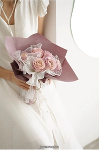 Detailed view of pink roses wrapped in Korean pleated pearl mesh fabric with a lace ribbon