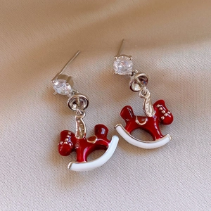 Detail view of 18K gold plated rocking horse earrings with red enamel and zircon stud