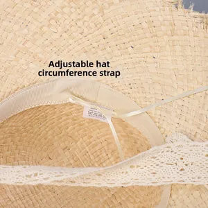 Detail of the raffia sun hat interior showing the sweatband and adjustable size strap