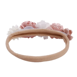 Close-up of pink and white fabric flower headband with high-elastic beige nylon band