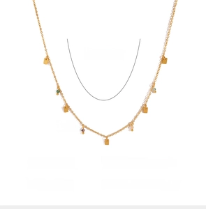 Detail view of 18K gold PVD coated stainless steel chain with square plates and crystals