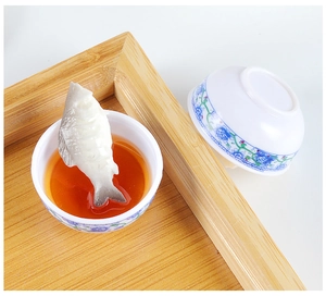 Macro detail of miniature fish soup bowl toy with blue and white porcelain pattern