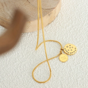 Golden snake chain necklace with star-patterned zircon circle and Good Luck pendant