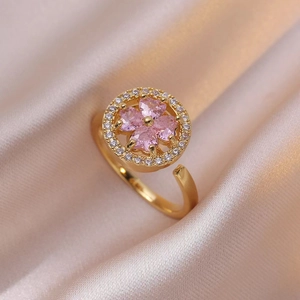 Gold rotating four-leaf clover ring with pink heart zircons and adjustable open band