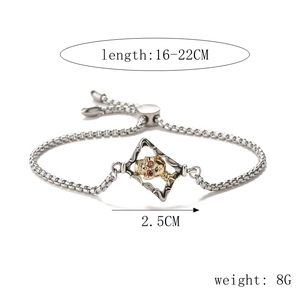 Detail view of two-tone skull bracelet with evil eye zircon and adjustable chain specs