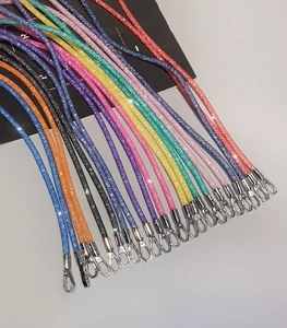 Close-up of glitter rhinestone mobile phone lanyards with silver lobster clasps