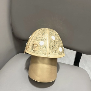 Detail view of mushroom-shaped handbag with rhinestone inlay and gold PU leather finish