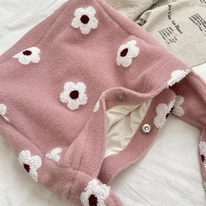 Detail of pink plush tote bag showing soft floral embroidery and magnetic closure