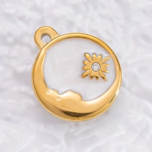 Macro shot of 18K gold plated heart tarot pendant with moon motif and zircon