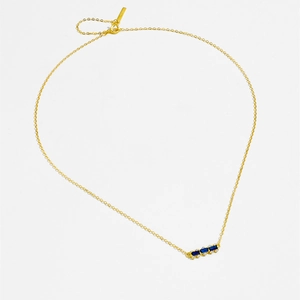 Macro shot of 925 sterling silver gold necklace with three blue rectangular gemstones