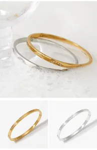 Close-up of waterproof wavy stainless steel bracelets with sparkling zircon stones