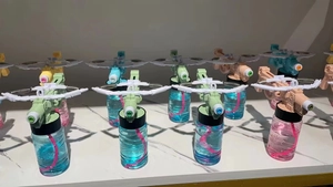 Multiple colorful crossbow bubble guns on a marble surface showing spring and gear details