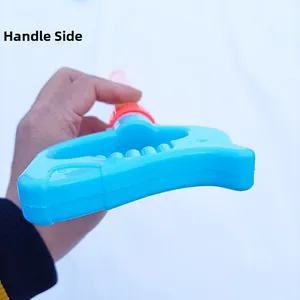 Detail of blue plastic water gun handle with red accents and ergonomic wave grip design