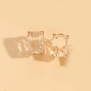 Detail view of emerald cut square crystal earrings with golden four-prong setting