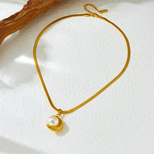 Elegant gold crescent moon pendant necklace with white pearl on snake chain