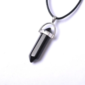 Macro detail of hexagonal black obsidian crystal pendant with silver clasp and leather cord