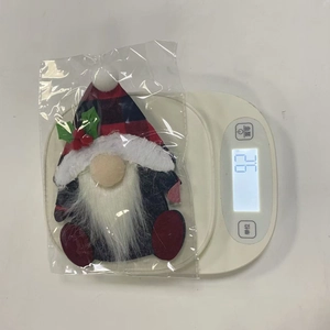 Close-up of a Christmas gnome cutlery holder in red and black plaid fabric design