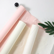 Detail of waterproof dual-color flower wrapping paper with diamond texture in soft colors