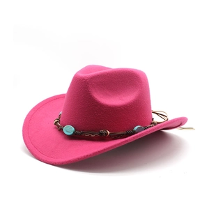 Detail of rose red felt cowboy hat with turquoise beads and brown braided band