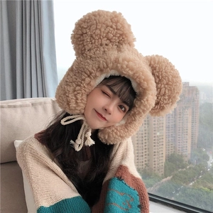 Detail of camel plush bear hat showing soft lamb wool texture and braided chin straps