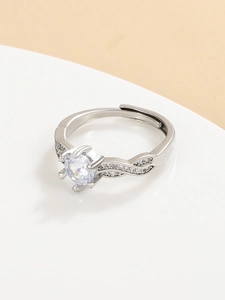 Macro detail of six-prong crown ring with twisted silver band and adjustable opening