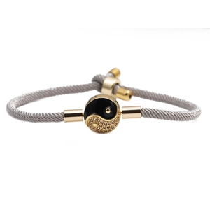 Adjustable grey woven rope bracelet with gold Yin Yang charm and sliding fastener