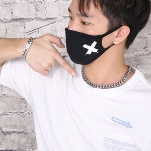 Detail of silver Cuban link necklace and diamond-encrusted bracelet set on male model