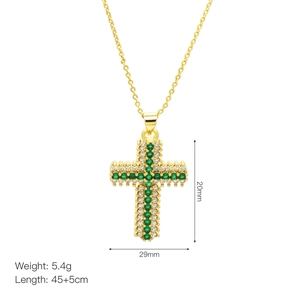 Detail view of gold cross pendant with dimensions 29x20mm and green zircon stones
