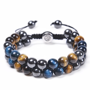 Detail of double-layer woven bracelet with blue tiger eye, hematite and Om charm