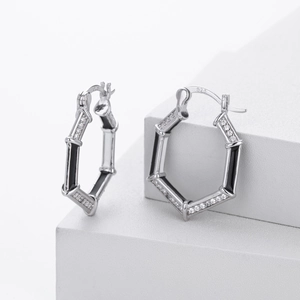 Macro shot of S925 sterling silver hexagonal earrings with zircon inlay and black accents