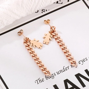 Detail of rose gold long drop earrings featuring girl charms and thick Cuban chains