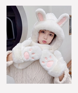 Detail of soft white plush hooded scarf featuring bunny ears and pink cat paw gloves