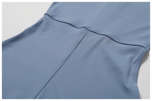 Close-up of high-quality stitching and elastic fabric on blue yoga jumpsuit