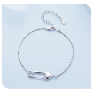 Detail of S925 sterling silver heart safety pin bracelet with cubic zirconia accents