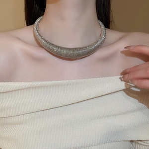 Close-up of silver chunky choker necklace with detailed spiral metallic wire texture