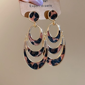 Golden crescent layered leopard print earrings with circular stud in a retro style