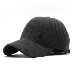 Close-up of winter outdoor baseball cap featuring thick dark gray twill fabric and side logo
