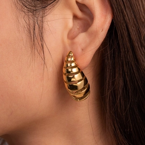 Polished gold-plated layered spiral C-shape earrings with a unique textured teardrop design