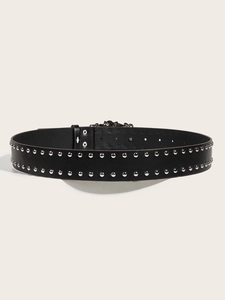 Detail view of a black punk leather belt with double rows of silver metal studs and buckle
