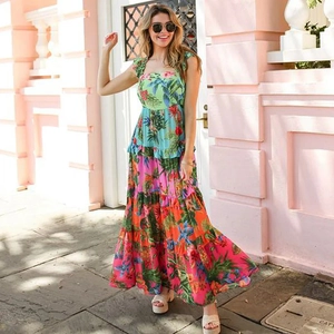 Detail of tropical floral print maxi dress featuring layered tiered skirt and vibrant colors