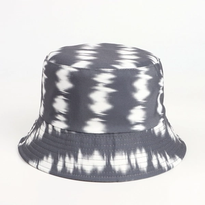 Close-up of canvas bucket hat featuring grey tie-dye pattern and reinforced brim stitching