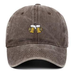 Detail of beer mugs embroidery on washed cotton baseball cap with vintage texture