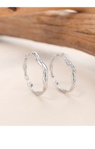 Close-up of 925 sterling silver Mobius rings with pavé cubic zirconia and twist design