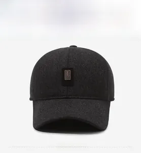 Detail of dark grey wool winter golf cap with ear protection and embroidered sport logo