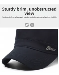 Detailed close-up of navy flat top cap with silver Jeans metal badge and stitching