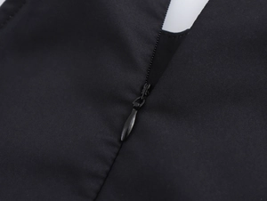 Detail of the back invisible zipper and V-neck design on a black vintage maxi dress