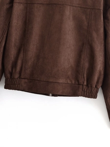 Close-up of brown faux suede jacket showing hem stitching and matte texture