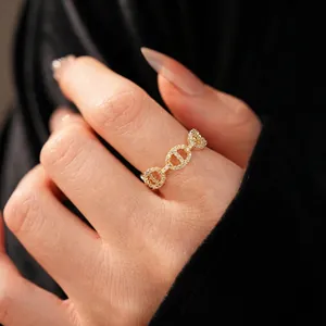 Luxurious gold-plated pig nose ring with white zircon stones on black background