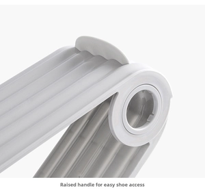 Detail of grey plastic shoe rack featuring a prominent handle for easy access