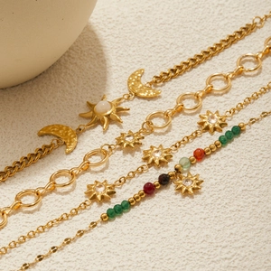 Three-piece gold stainless steel bracelet set with sun, moon, and gemstone charms